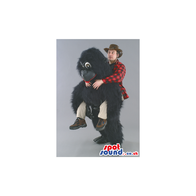 Tall fluffy black gorilla mascot with red lips and brown eyes -