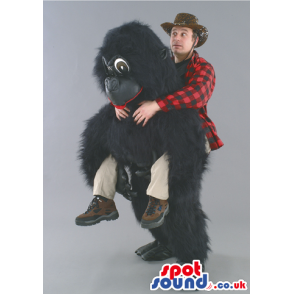 Tall fluffy black gorilla mascot with red lips and brown eyes -