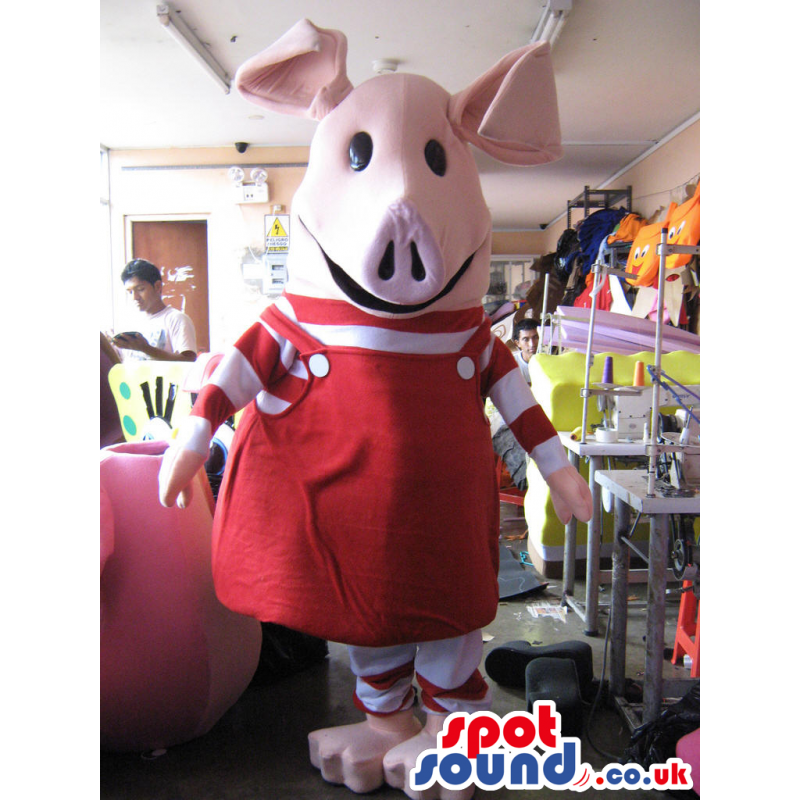Tall, giant-headed pig mascot with red and white overalls -