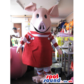 Tall, giant-headed pig mascot with red and white overalls -