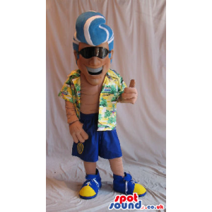 Cool Man Mascot With A Blue Hairdo In A Summer Shirt And Logo -