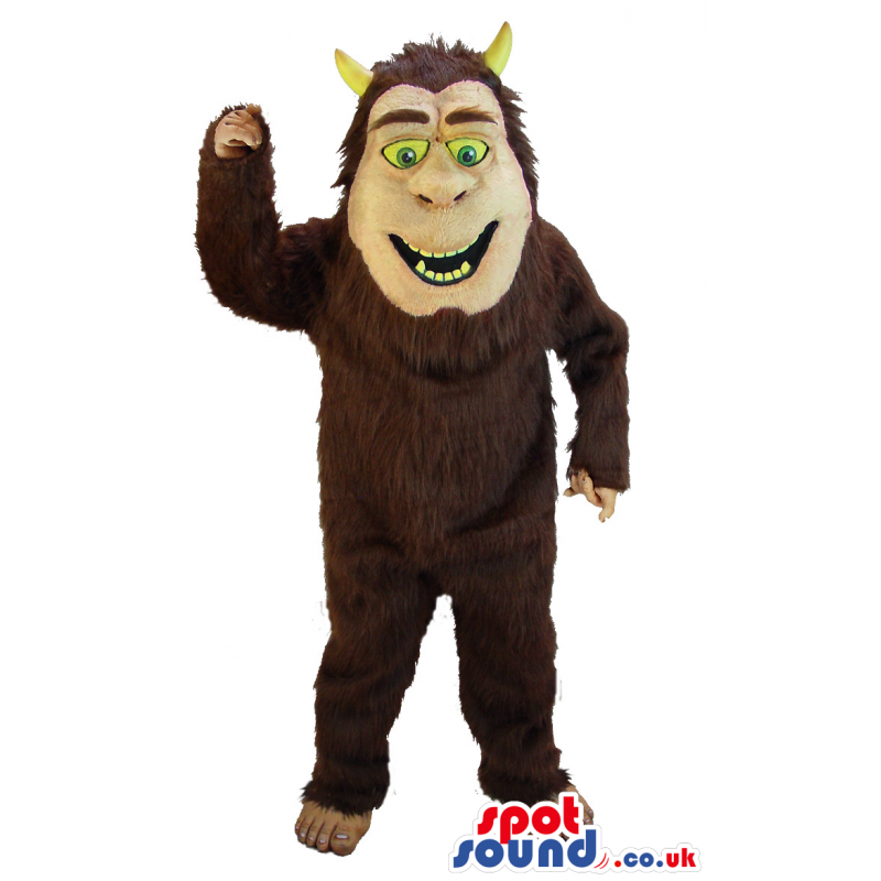 Hairy brown devil mascot with yellow eyes,teeth and horns -