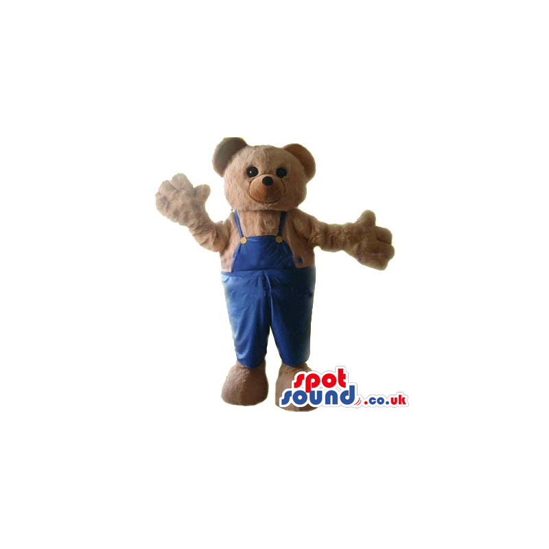 Cute Brown Teddy Bear Plush Mascot Wearing Blue Overalls. -