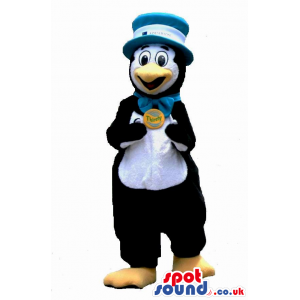 Funny Penguin Plush Mascot In A Bow Tie And Hat With A Badge