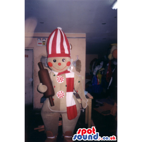 Happy gingerbread mascot with red and white outfit and roller -