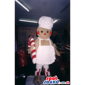 Giant gingerbread mascot wearing white apron and holding candy