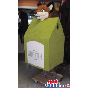 Brown Fox Plush Mascot Inside A Green House With A Label -