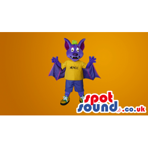 Purple Fantasy Bat Plus Mascot Wearing A Yellow T-Shirt -