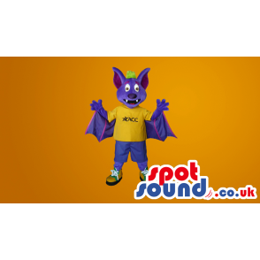 Purple Fantasy Bat Plus Mascot Wearing A Yellow T-Shirt -
