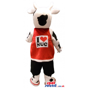 Black And White Cow Plush Mascot Wearing A Red Shirt With