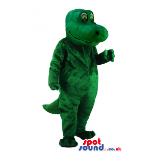 Delighted looking green lizard mascot with green eyes and tail