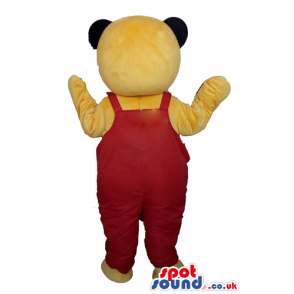 Bear mascot looking to the front with red gardener trousers -