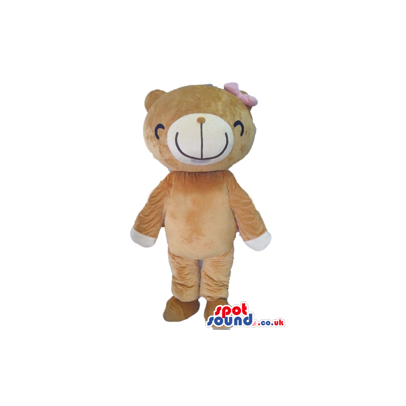 Female light brown bear mascot with a pink bow and a smiling