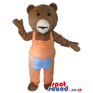 Brown teddy bear mascot in pink gardener trouseres with a