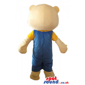 Smiling light-brown teddy bear with small red nose with blue