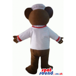 Chocolate brown teddy bear with beige hands in white sailor