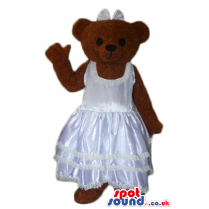 Chocolate brown teddy bear in silky white wedding dress -