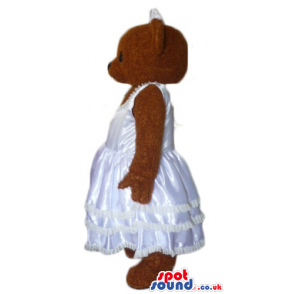 Chocolate brown teddy bear in silky white wedding dress -