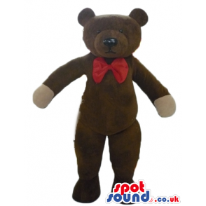Serious brown teddy bear with beige hands and red bow tie -