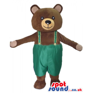 Smiling brown teddy bear with details in beige wearing green