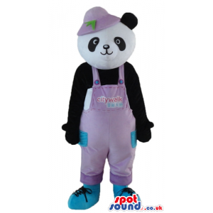 Panda bear dressed in pink gardener trousers, a pink hat and