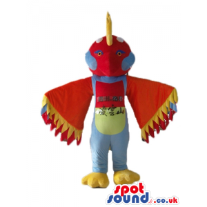Purple bird with big red head with yellow detail on top, with