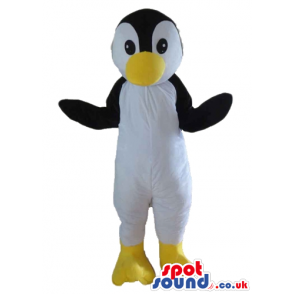 Black and white penguin with big yellow beak and yellow feet -