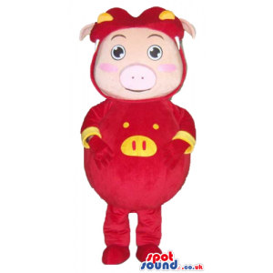 Smiling pink pig wearing a red suit with yellow details and a