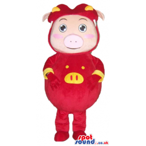 Smiling pink pig wearing a red suit with yellow details and a