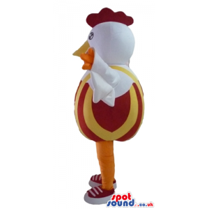 white cock with red hair and yellow leg with a red and orange