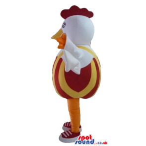 white cock with red hair and yellow leg with a red and orange