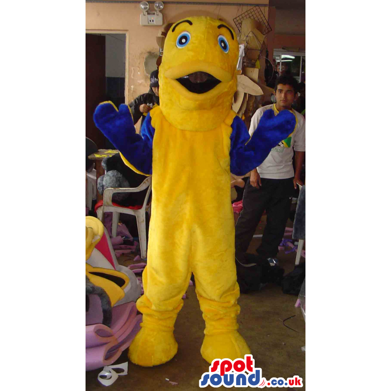 Giant yellow fish mascot with blue hands and yellow feet -