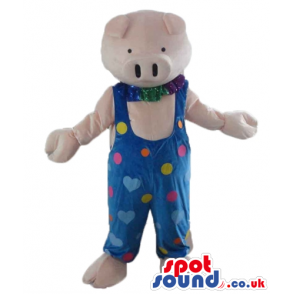 Pink pig wearing a blue gardener trousers with pink, yellow