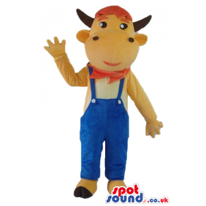 Beige cow wearing blue gardener trousers, a red handkerchief