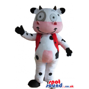 Smiling white cow with black spots, pink belly and mouth, a