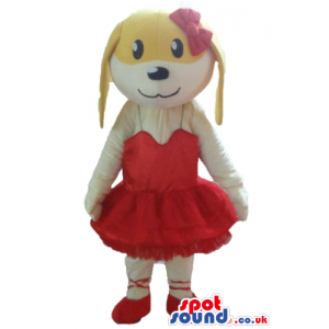 Female beige and white dog wearing a red ballet dress and red