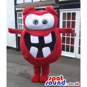 Red monster mascot with big round eyes and white squared teeth