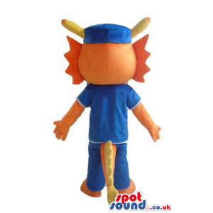 Orange monster dressed in a blue t-shirt, blue trousers and a