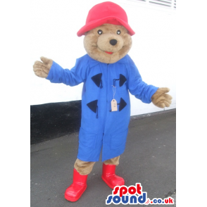 Bear mascot wearing red hat and long blue coat and red boots -