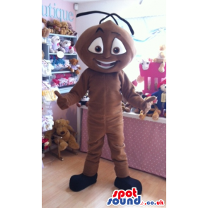 Giant standing brown ant mascot with thick black antennae -