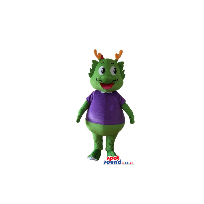 Green smiling monster with orange horns wearing a violet