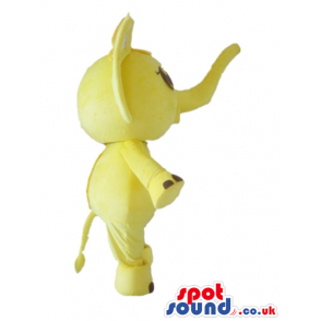 Yellow elephant with white ears and a yellow and black ribbon -