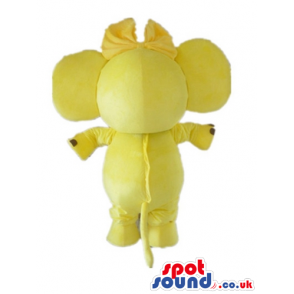 Yellow elephant with white ears and a yellow and black ribbon -