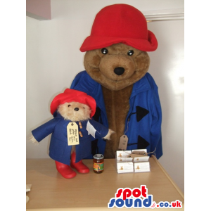 Brown bear mascot and teddy with red hat and blue jacket -