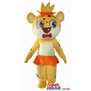 Yellow lioness with big eyes, an orange bow on the head and an